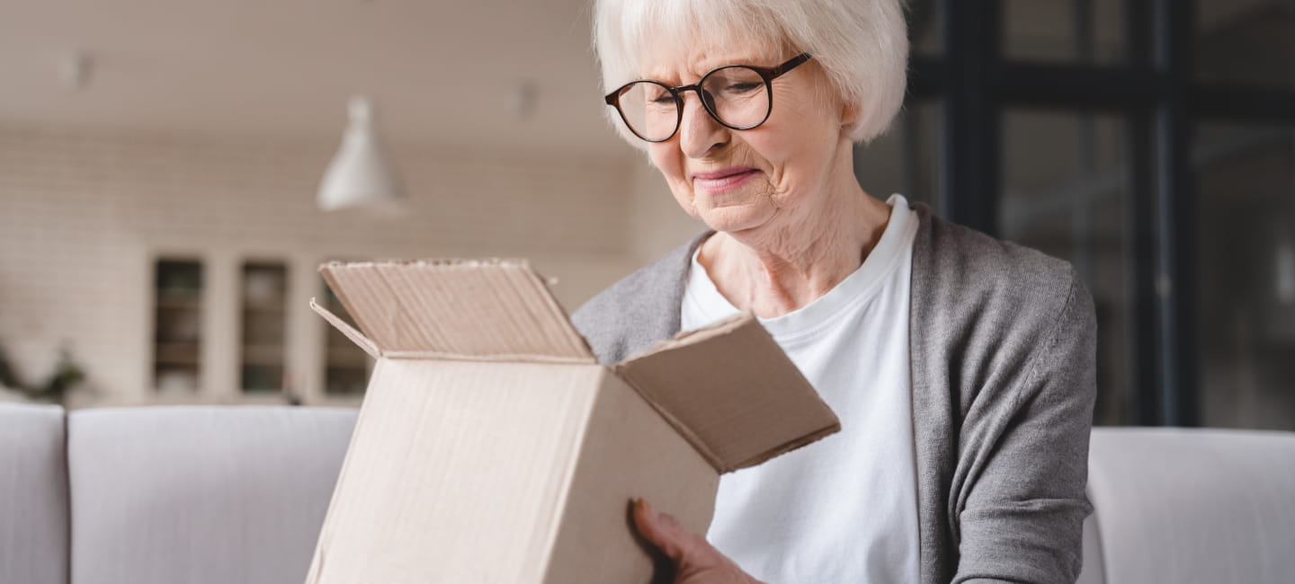 A woman opening a parcel 