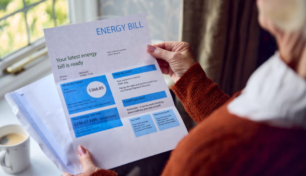 A person looking at a letter discussing their energy bill
