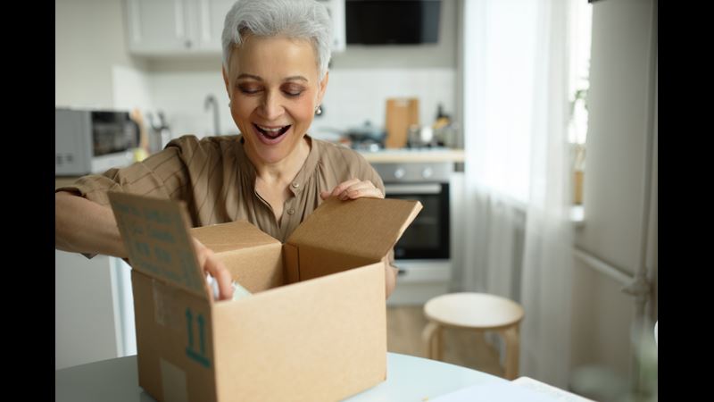 Smiley woman opening box 