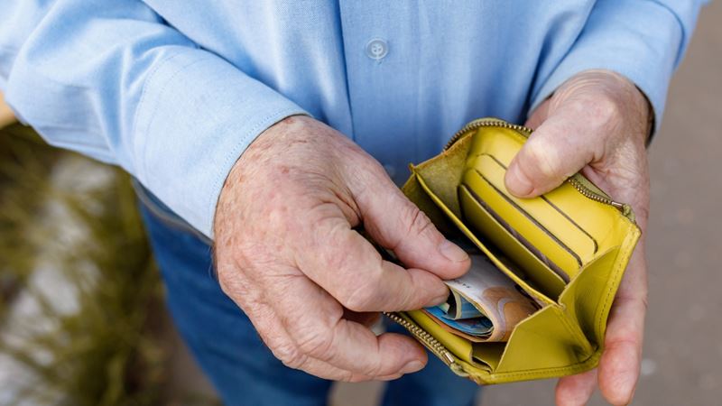 A man removing money from a purse