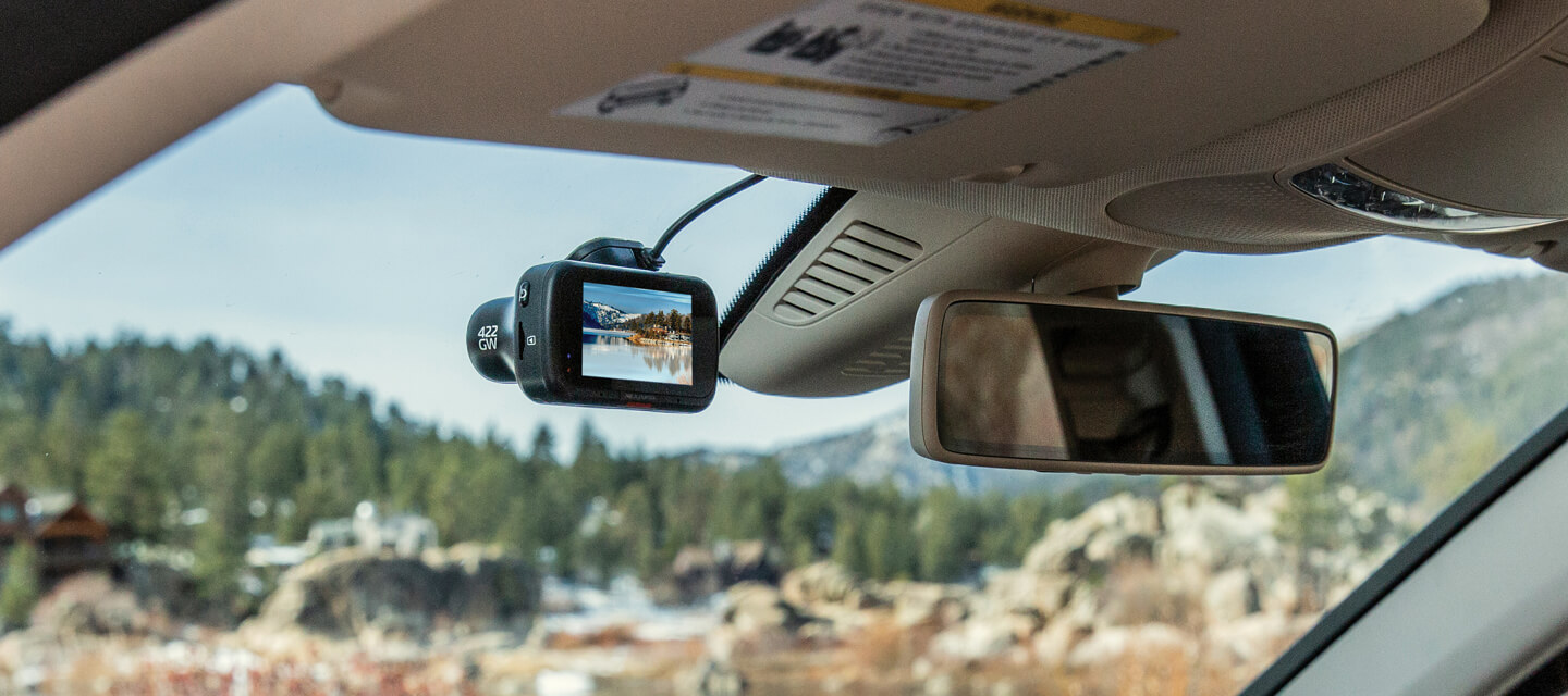 A dashcam mounted on a car windscreen