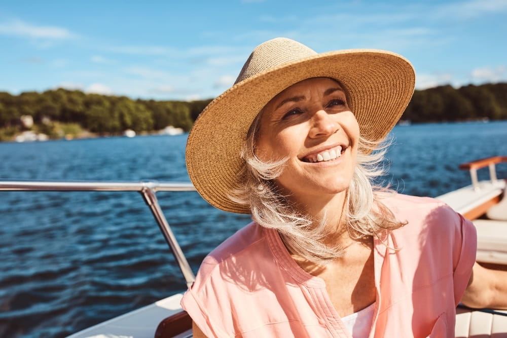 A woman smiling on a boat in the sea
