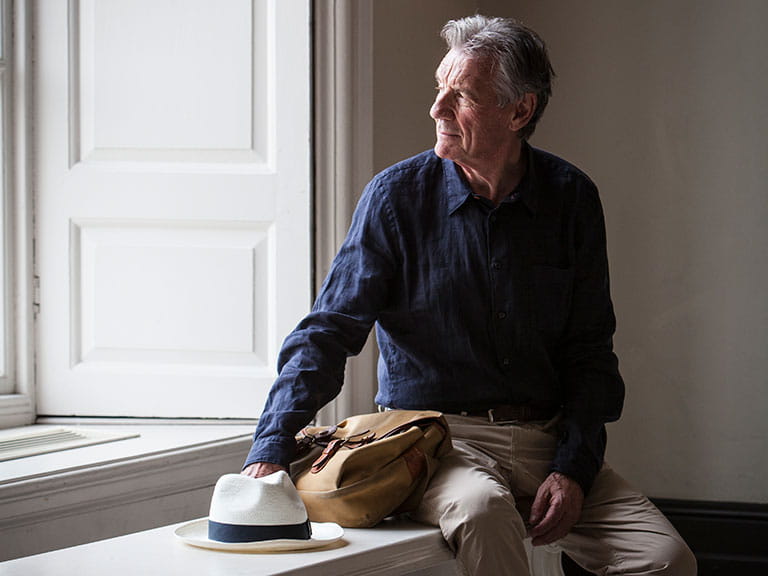 Michael Palin stares pensively out of a window 