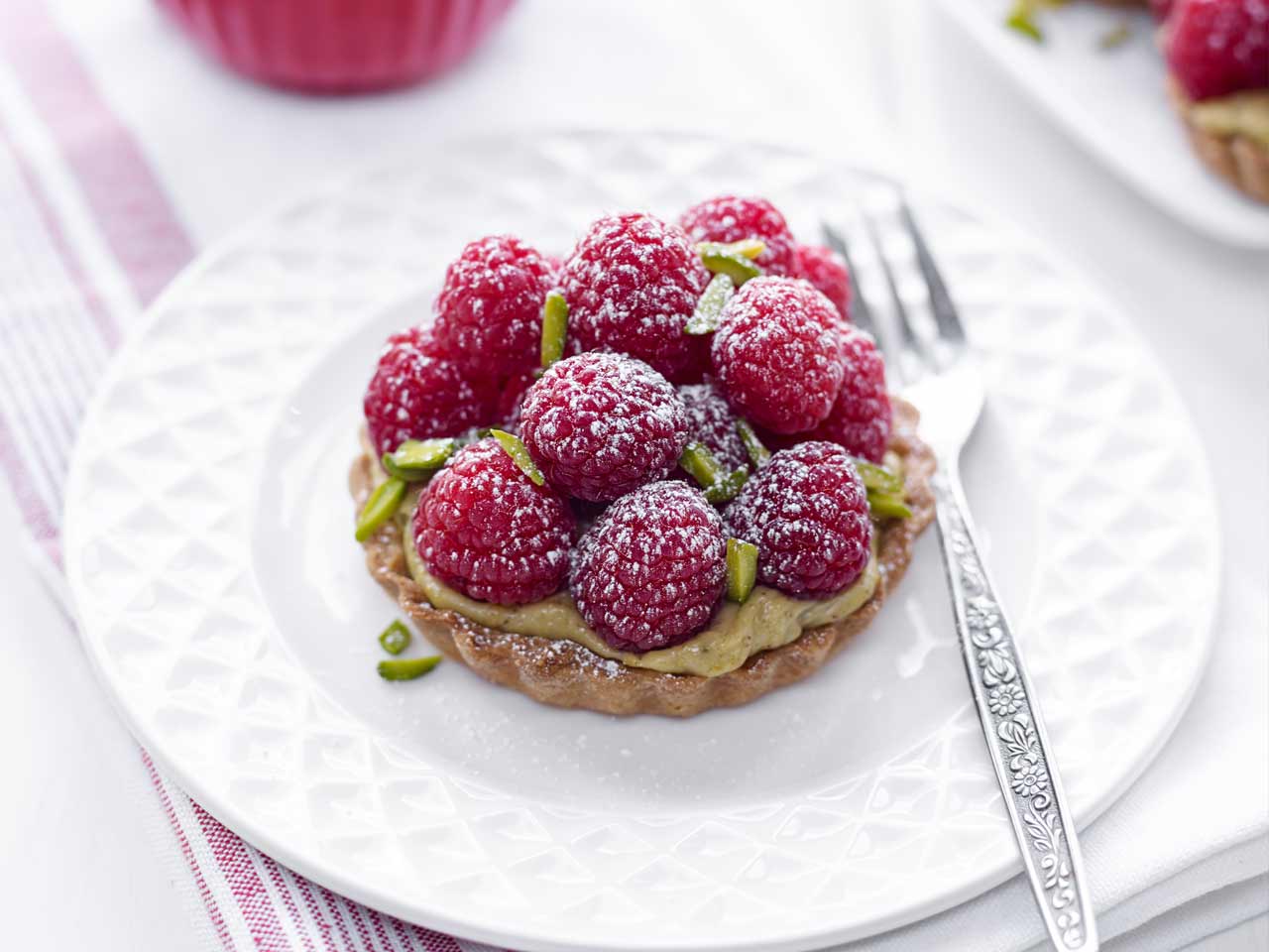 Raspberry and pistachio tarts