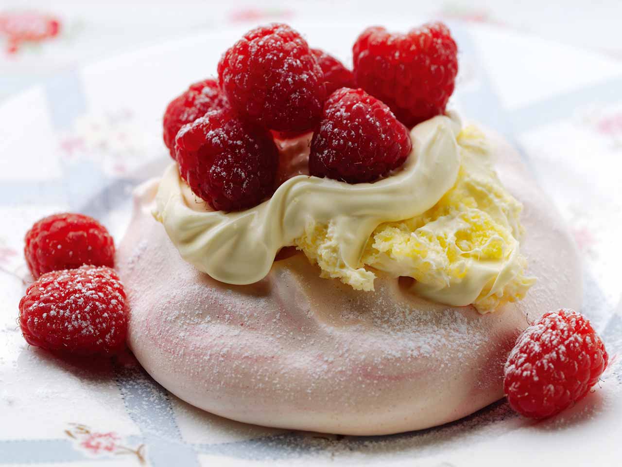 Mini pavlova with clotted cream and raspberries