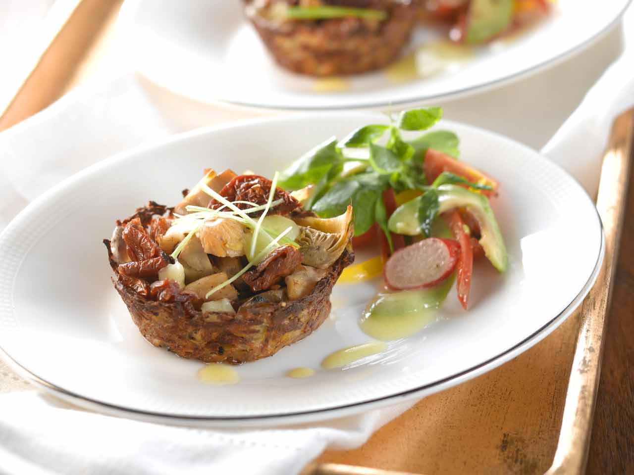 Potato nests with artichokes, oyster mushrooms and sun-dried tomatoes