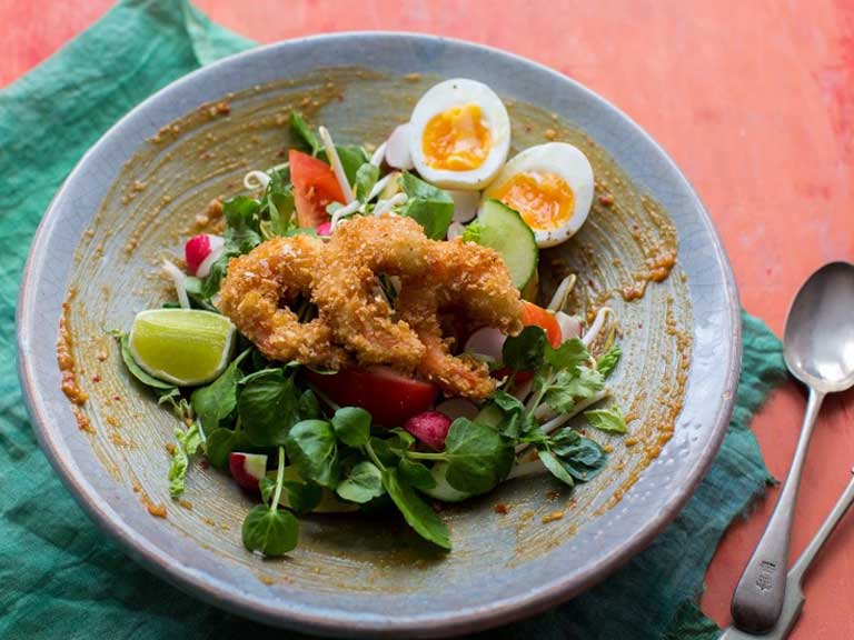 Indonesian gado gado salad with crunchy tiger prawns and watercress