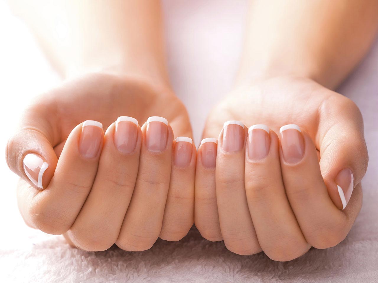 Woman's hands held out showing fingernails