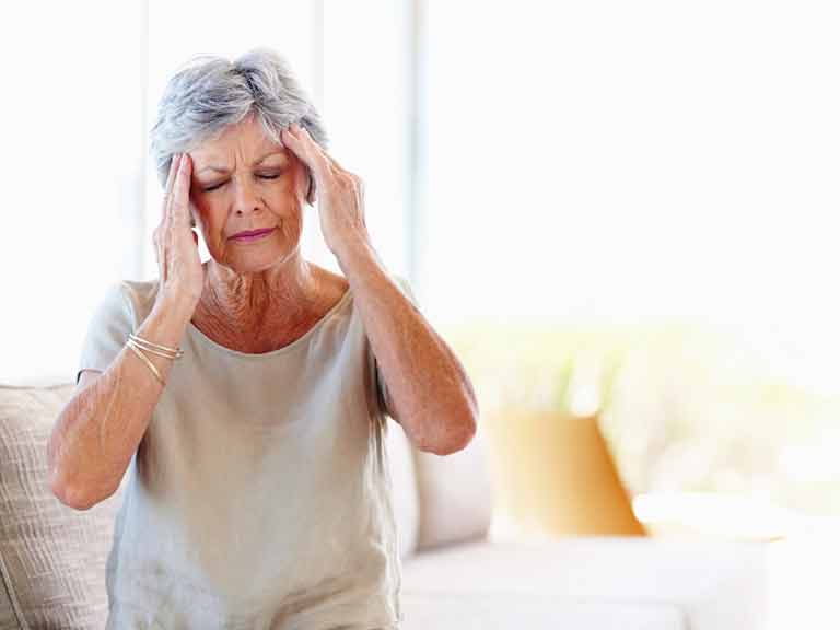 Woman with headache or migraine