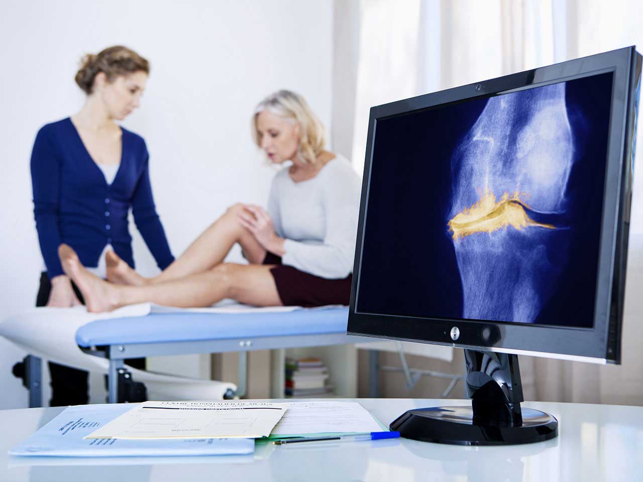 Consultant looking at patient's knee