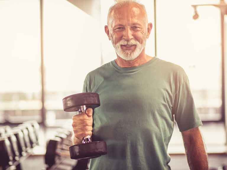Man exercising with weights in a gym