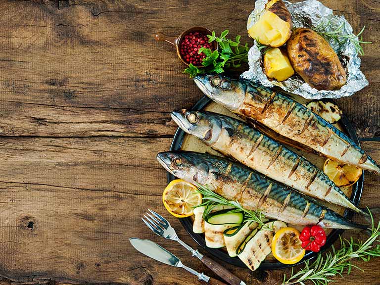 Grilled mackerel with baked potato and salad