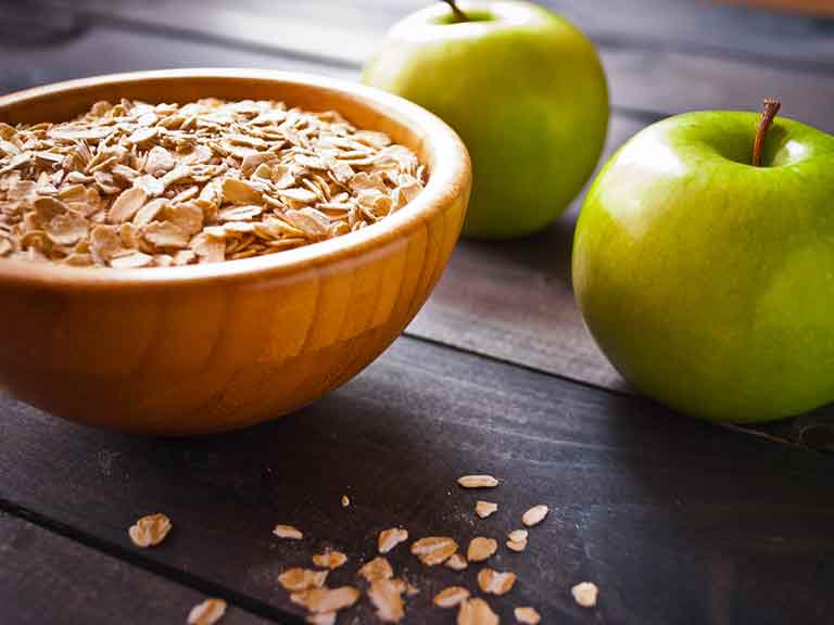 Oats and apples are two foods that may be helpful in helping to lower LDL cholesterol