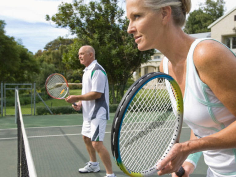 Woman and man playing tennis
