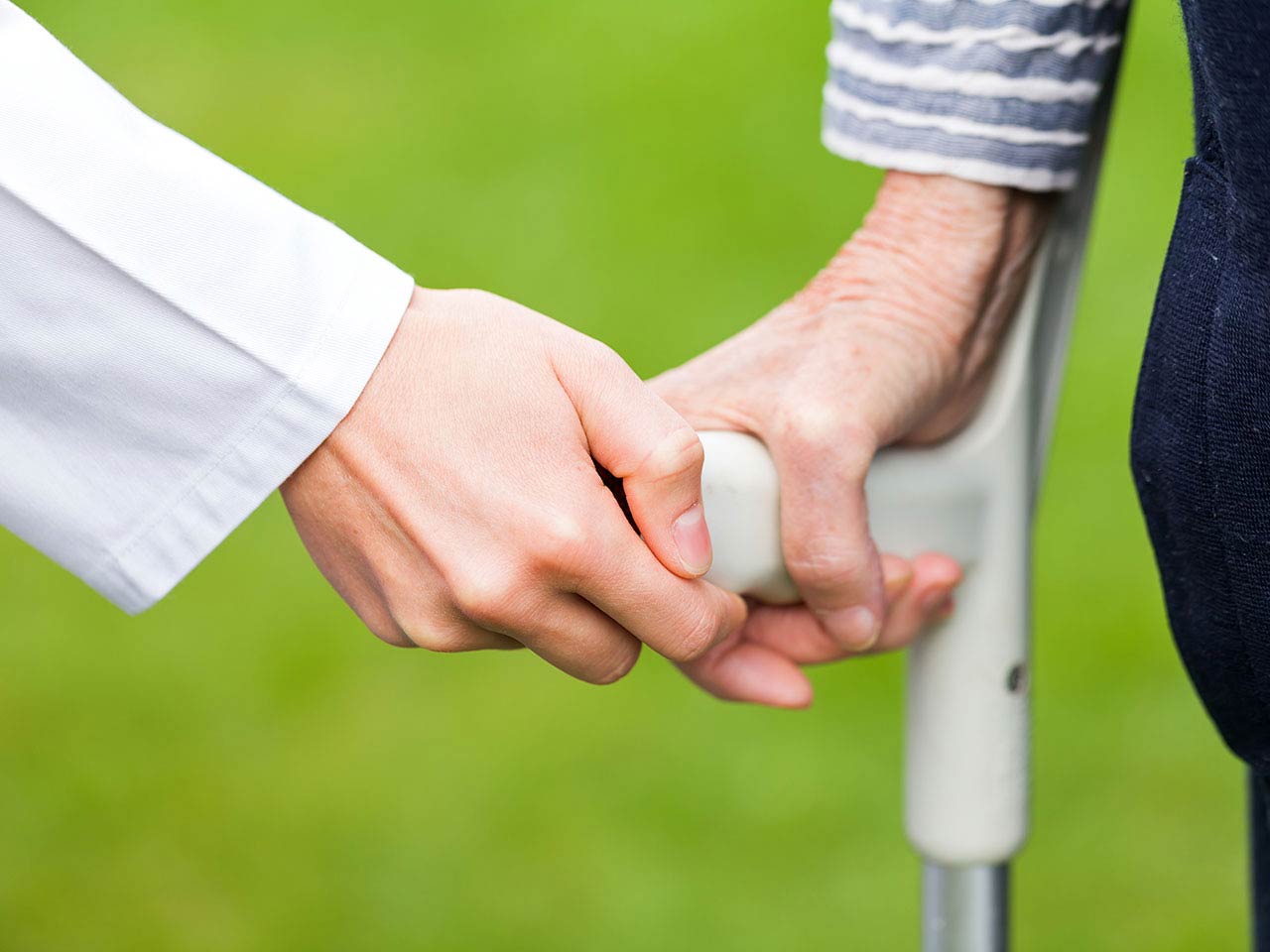 Woman using crutches with medical professional