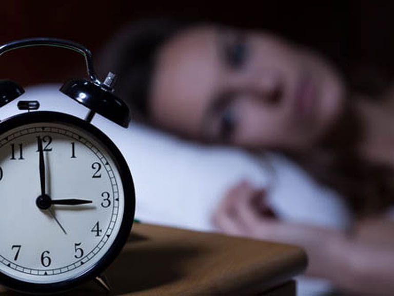 Woman lying awake, unable to sleep