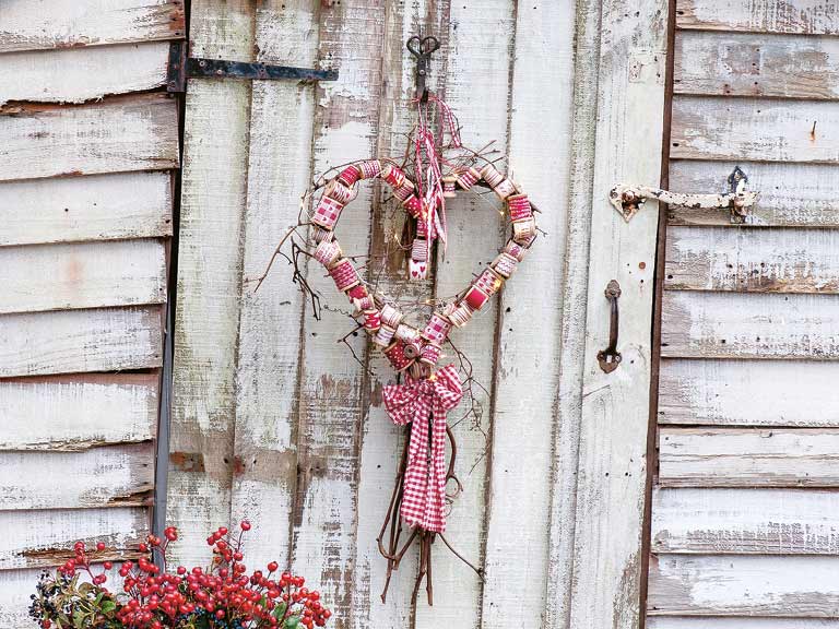A Christmas heart wreath on a shed door