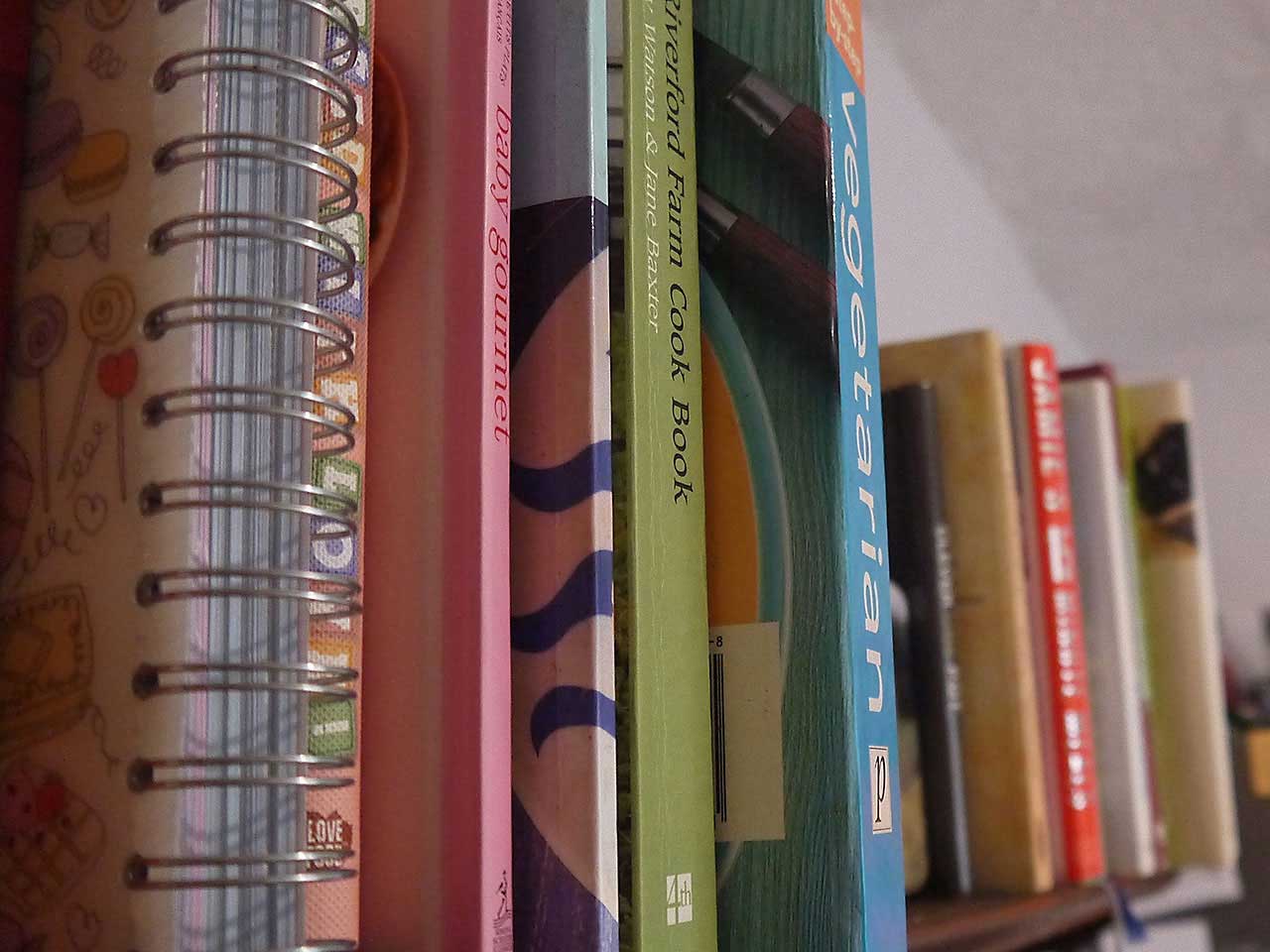 Cookery books on a shelf in the kitchen