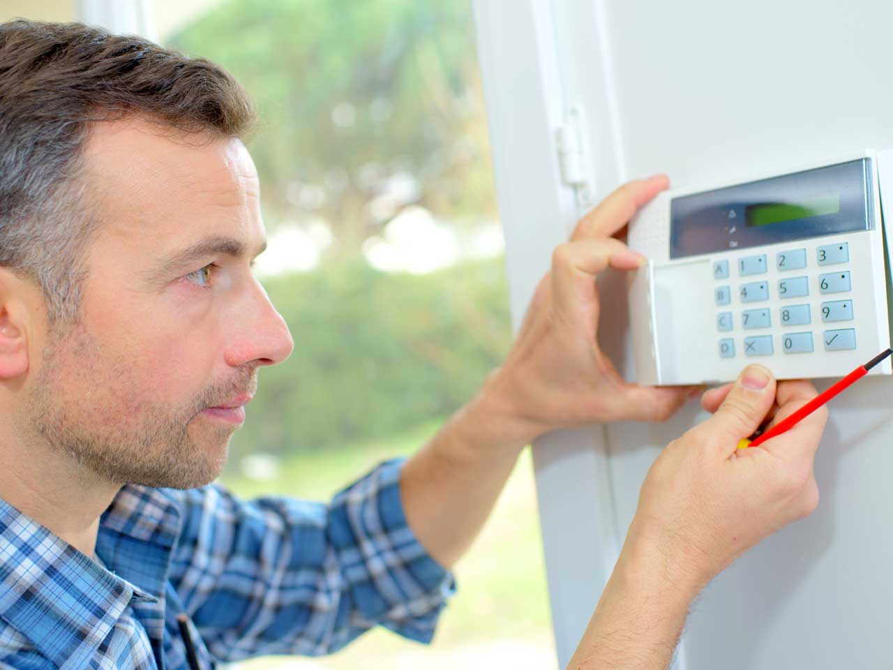 Electrician wiring in a burglar alarm