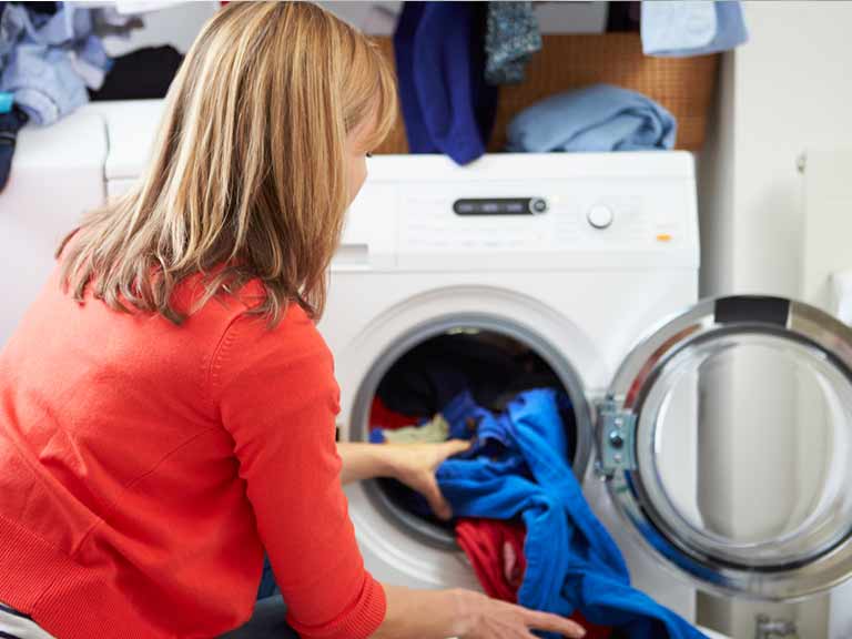Woman laundering clothes and bedding