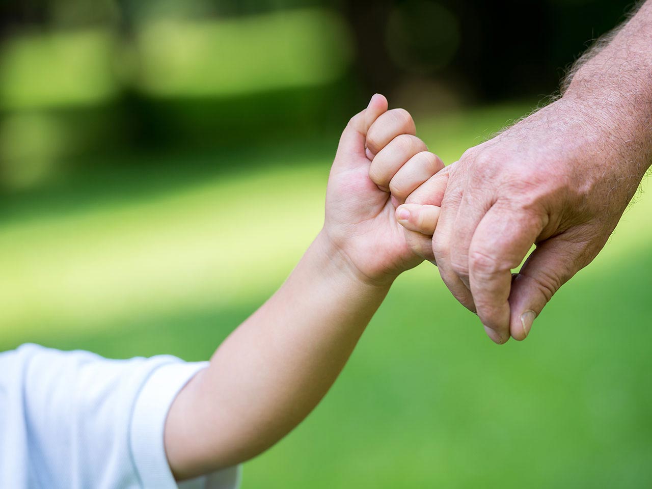 Grandad holding grandson's hand