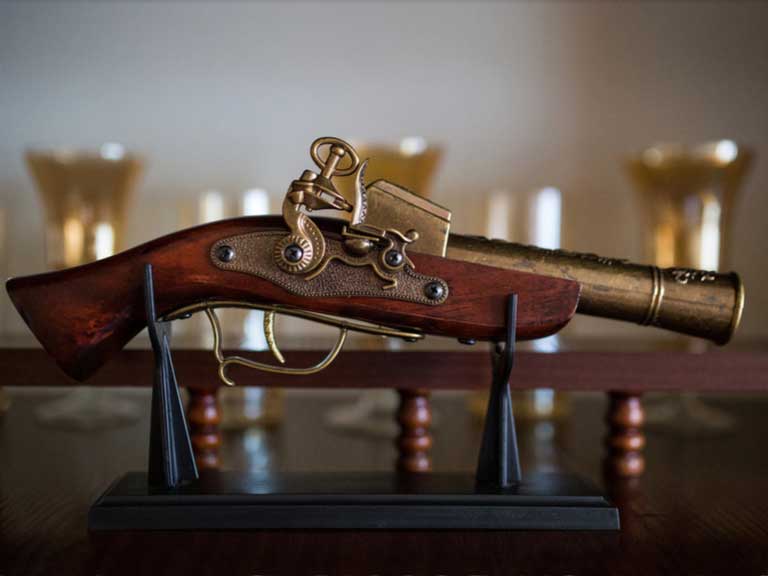 An old pistol on a display stand
