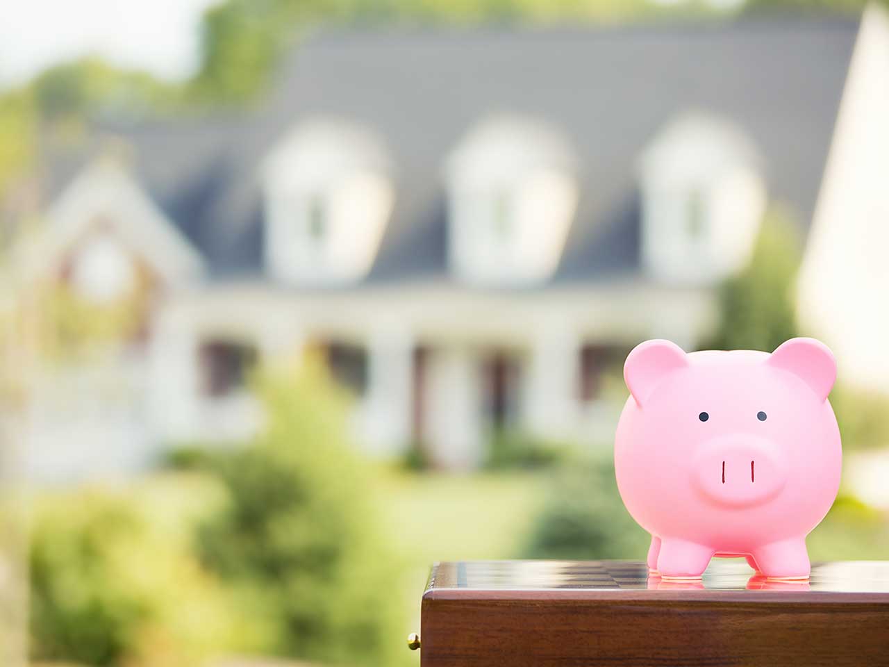 Piggybank in front of a house