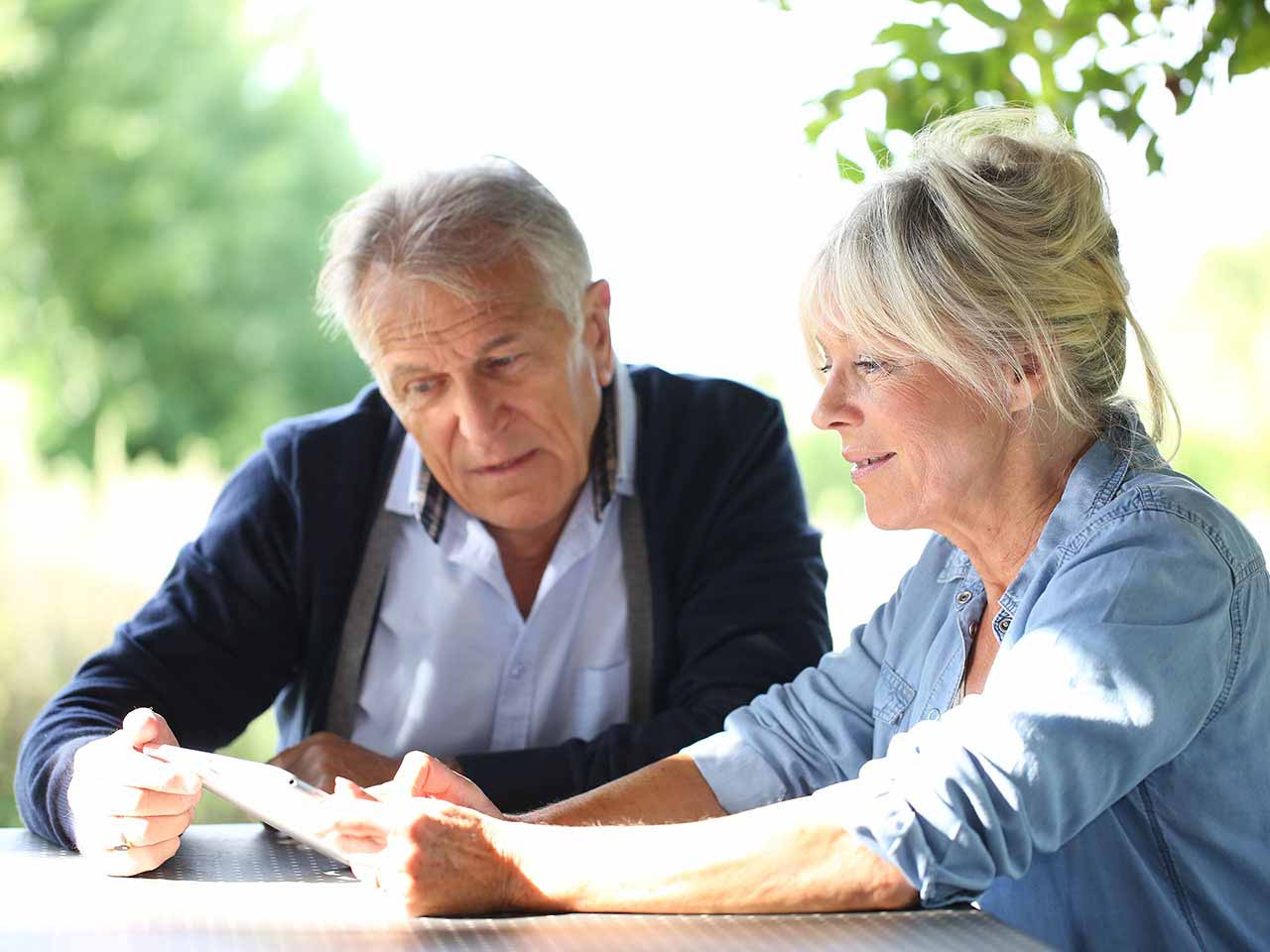 Mature couple looking at tablet