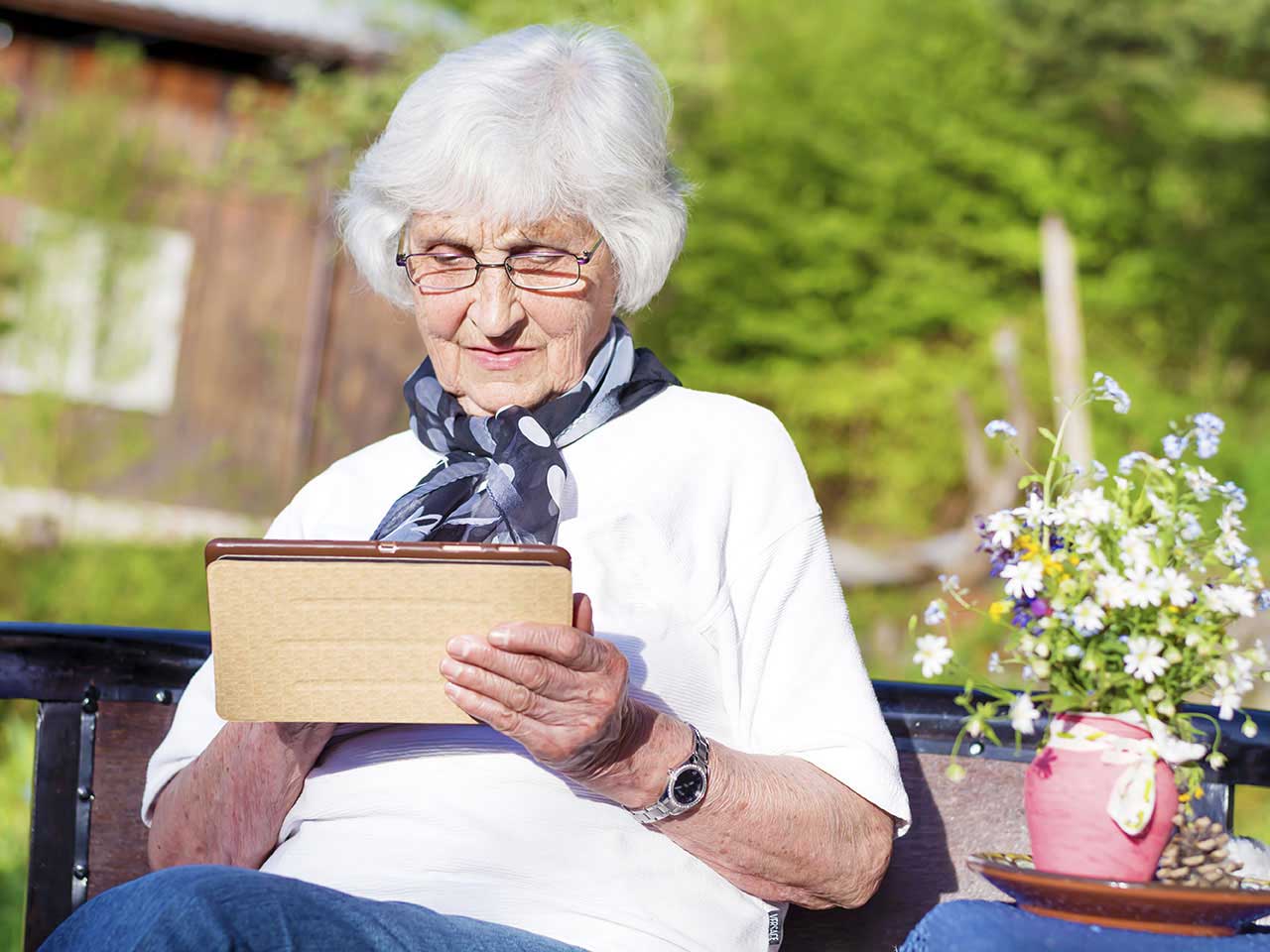 Senior woman looking at digital tablet