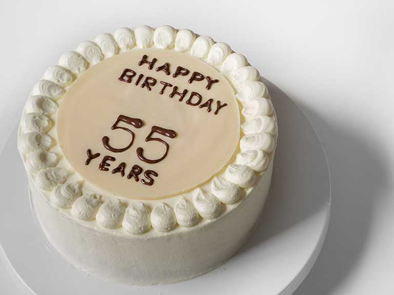 A birthday cake with 55 written in icing