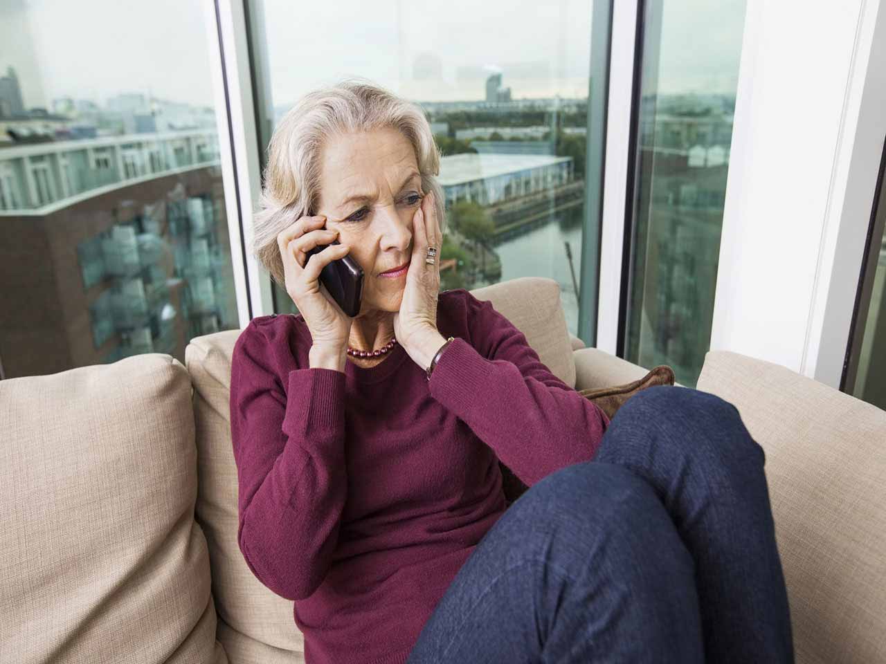 A mature woman receiving a nuisance phone call