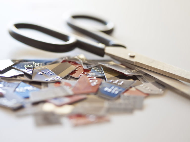 Pair of scissors cutting up credit cards