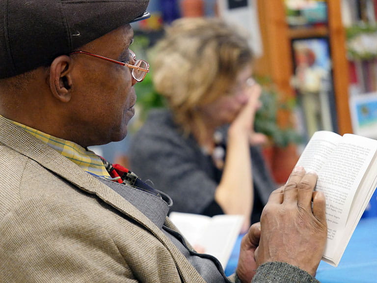 Two older people enjoy the benefits of shared reading