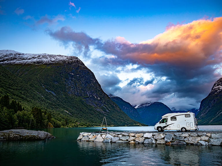 A caravan parked by a peaceful lake