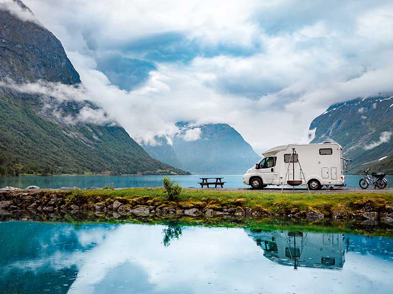 A caravan parked by a beautiful lake