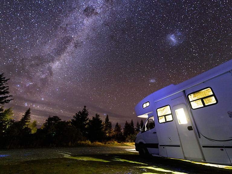 A motorhome parked under the stars