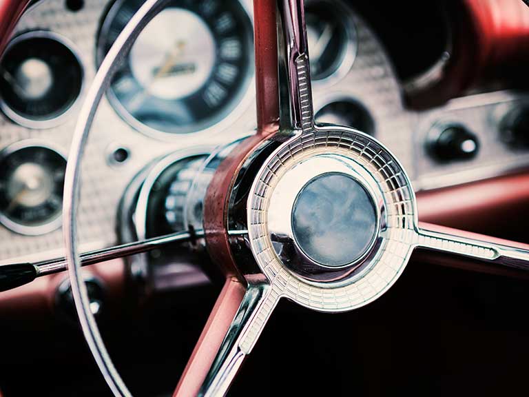 A steering wheel of a traditional classic car