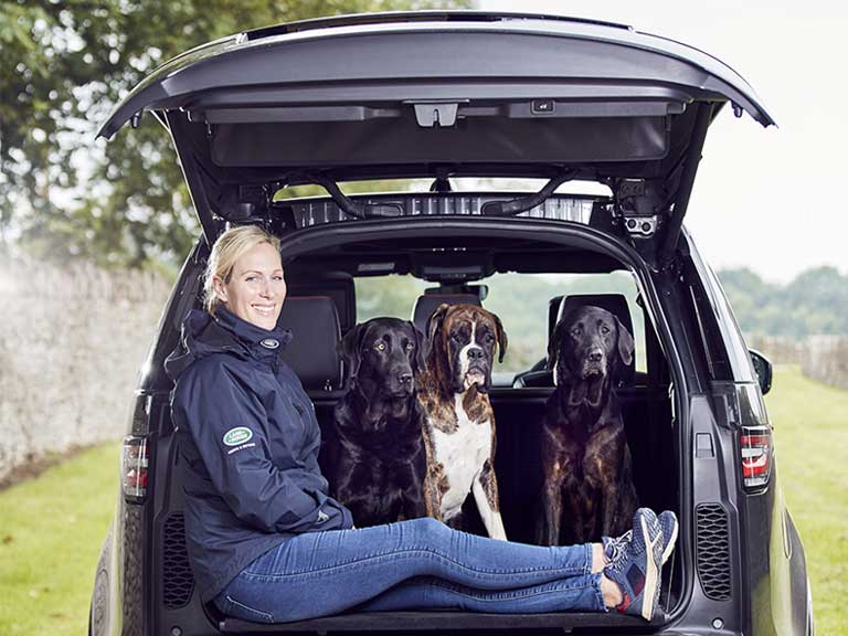 Zara Tindall relaxing in the back of a Land Rover with her dogs