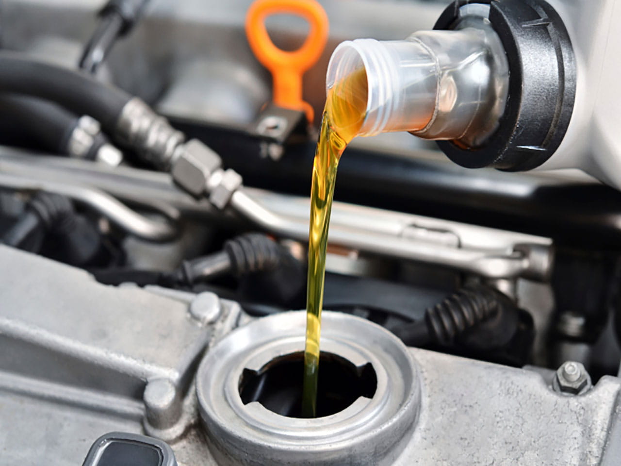 Topping up the oil in a car engine