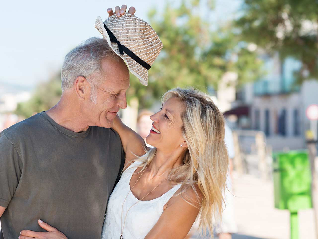 Mature couple messing about with a hat