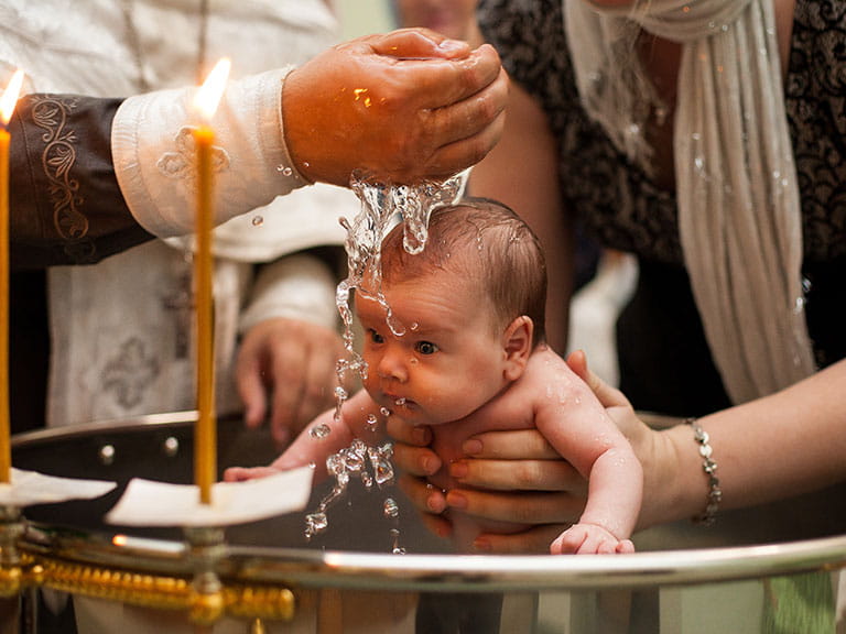 A small baby gets christened