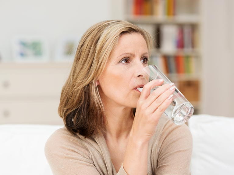 Senior woman drinking glass of water