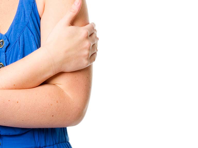 A woman hides her upper arms