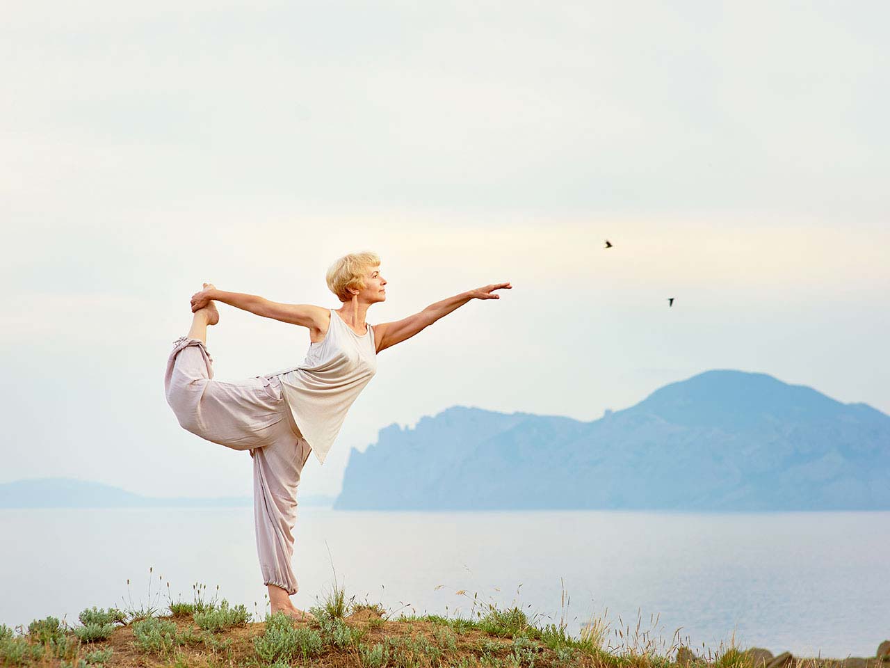 Mature woman practising yoga