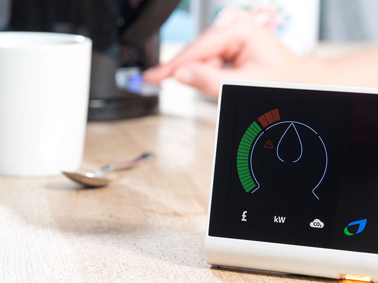 A smart meter recording the home's power usage on a table
