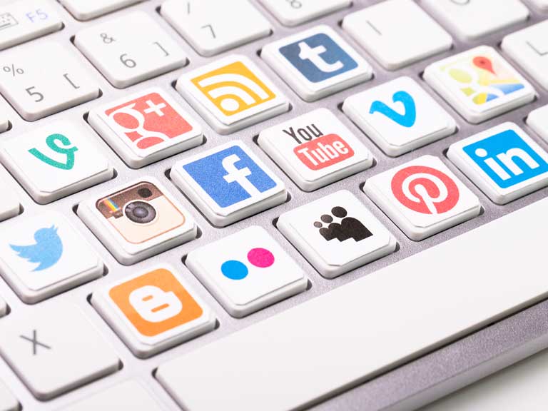 Social media platform logos on a keyboard