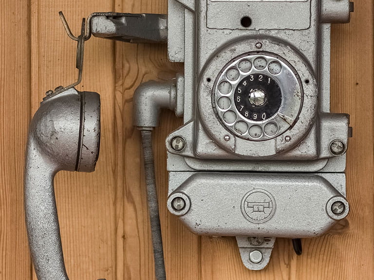 An old fashioned phone to playfully represent how mobile phones with big buttons and large screens have improved in recent years