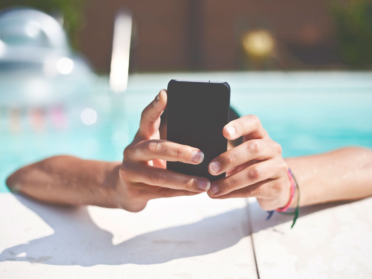 Using smartphone by the pool