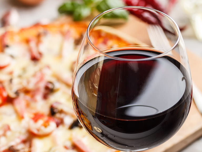 Close up of red wine and pizza