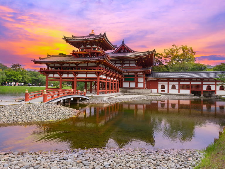 Uji, Kyoto, Japan - famous Byodo-in Buddhist temple with peaple at sunset time